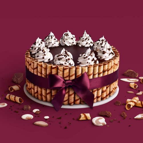 Ribbon Cake Our signature cake with layers of Midnight Cookies & Cream and Vanilla Chocolate Chip ice creams, layered with cookie crunch, surrounded by rolled wafer cookies and tied with a ribbon.
